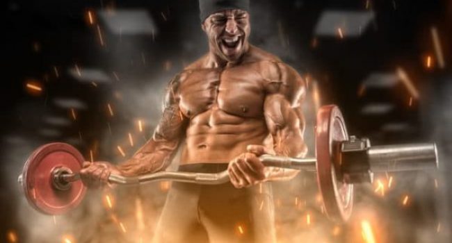 Intense athlete doing curls in the gym Intense athlete doing curls in the gym building muscle fast