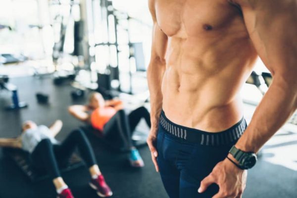 Fit people in gym who use natural fitness products